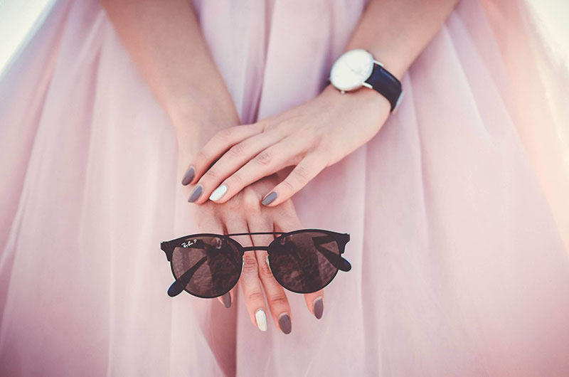 girl in a pink dress with glasses in her hands